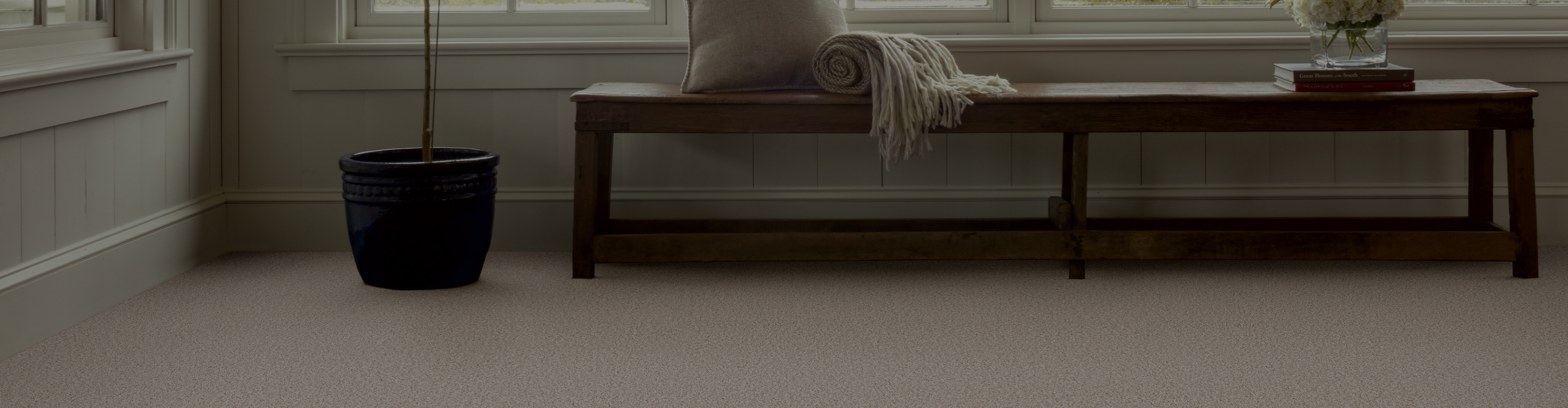 Living room with brown couch and two chairs, beige carpet